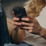 Sheridan’s Trusted HVAC Experts For Over 40 Years 4 Person using smartphone while sitting